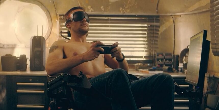Jack Reynor as Burton Fisher using a traditional VR headset with display and a handheld controller. As seen in The Peripheral (2022)