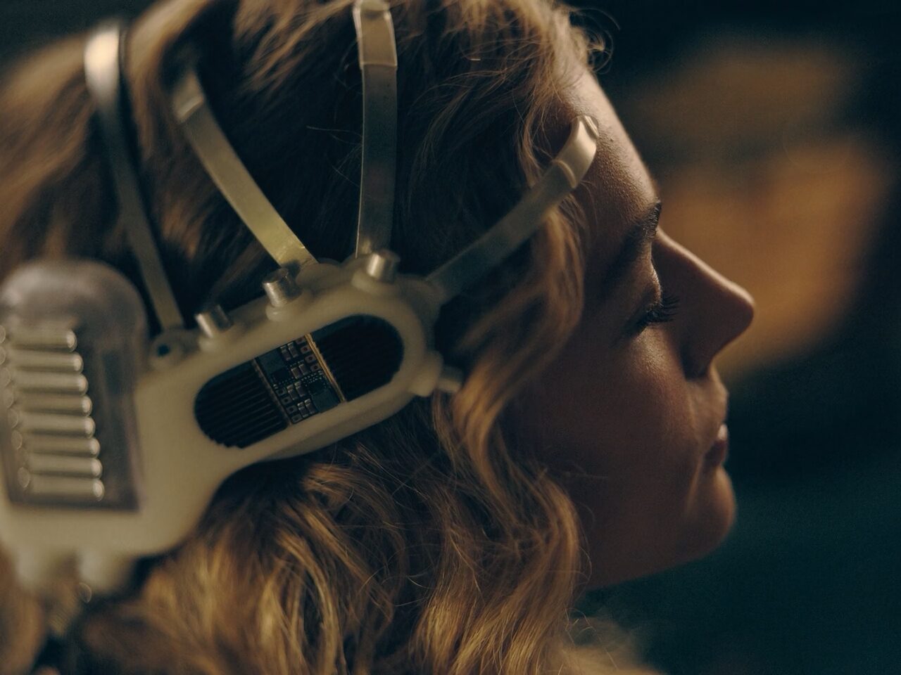 Side view of Chloë Grace Moretz as Flynne Fisher using a futuristic VR headset with direct neural interface. As seen in The Peripheral (2022)